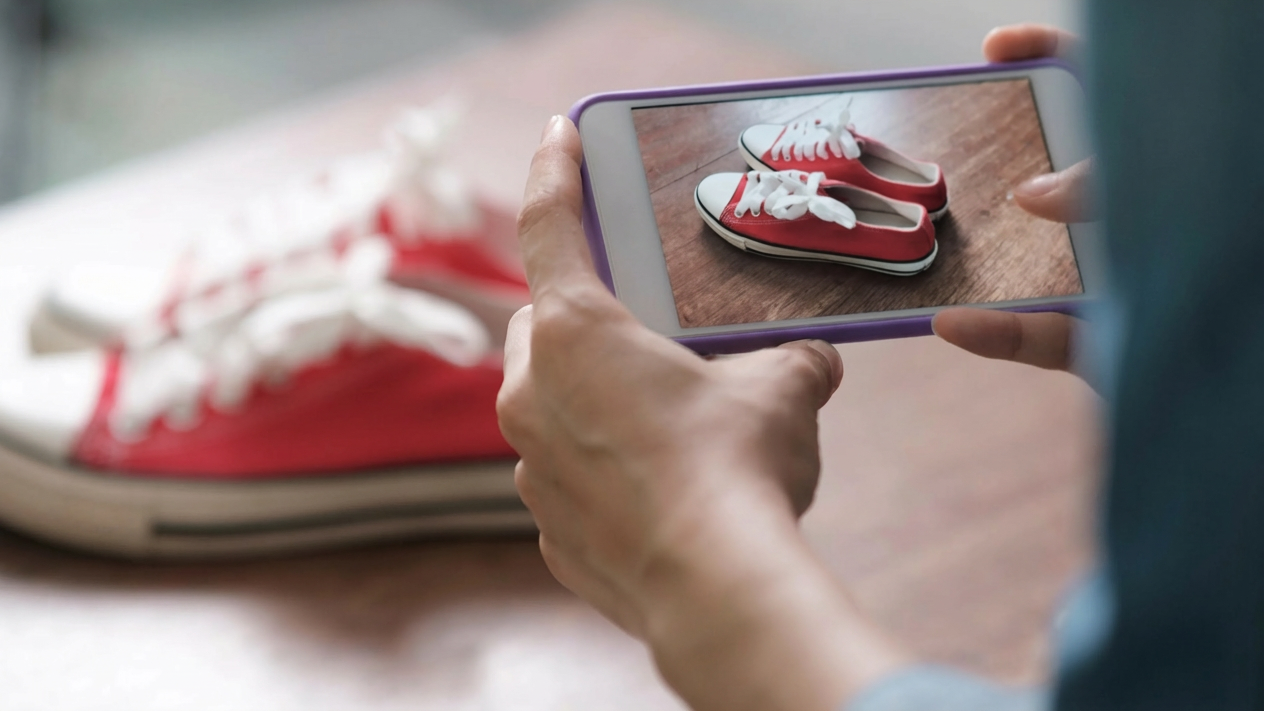Hand holding sneakers